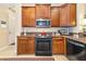 A kitchen featuring granite counters, stainless steel appliances, and wooden cabinets at 5246 Manorwood Dr # 4, Sarasota, FL 34235