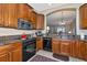 A kitchen featuring granite counters, stainless steel appliances, and wooden cabinets at 5246 Manorwood Dr # 4, Sarasota, FL 34235