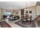 Open-concept living area with dining table, bar stools, and multiple seating areas at 5246 Manorwood Dr # 4, Sarasota, FL 34235