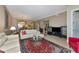 A living room with tile floors, neutral colors, an entertainment center, and an open access to other rooms at 5246 Manorwood Dr # 4, Sarasota, FL 34235