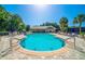Inviting pool with sun-drenched lounging areas and easy access steps and rails at 5246 Manorwood Dr # 4, Sarasota, FL 34235