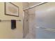 Modern shower with updated fixtures and tiled walls, plus a towel rack at 5246 Manorwood Dr # 4, Sarasota, FL 34235