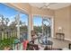 A relaxing sunroom boasting natural light and serene pond views at 5246 Manorwood Dr # 4, Sarasota, FL 34235