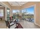 Inviting sunroom with tiled floor and tranquil views of the community pond at 5246 Manorwood Dr # 4, Sarasota, FL 34235
