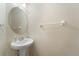 Powder room featuring a pedestal sink, an oval mirror, and modern fixtures at 5435 Soapstone Place # 22-103, Sarasota, FL 34233