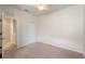 Bedroom with neutral carpet, a ceiling fan, and access to additional rooms at 5435 Soapstone Place # 22-103, Sarasota, FL 34233