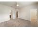 Large bedroom with neutral carpeting, ceiling fan, and a walk-in closet at 5435 Soapstone Place # 22-103, Sarasota, FL 34233