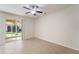 Bright bedroom with a ceiling fan and sliding glass doors that lead to a patio area at 5435 Soapstone Place # 22-103, Sarasota, FL 34233