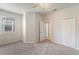 Neutral bedroom featuring carpet floors, a ceiling fan, and a window with blinds at 5435 Soapstone Place # 22-103, Sarasota, FL 34233