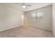 Bright bedroom with neutral carpet, a ceiling fan, and large window offering natural light at 5435 Soapstone Place # 22-103, Sarasota, FL 34233