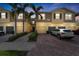 Townhome with paver driveway, one car garage and two stories with palm trees at 5435 Soapstone Place # 22-103, Sarasota, FL 34233