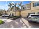 Townhome with a paver driveway, one car garage and two stories with palm trees at 5435 Soapstone Place # 22-103, Sarasota, FL 34233
