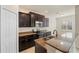 Kitchen with stainless steel appliances, dark brown cabinets and granite countertops at 5435 Soapstone Place # 22-103, Sarasota, FL 34233