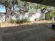 View of private backyard featuring a concrete fence and a gravel and mulch ground cover at 6024 Arlene Way, Bradenton, FL 34207