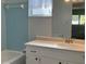 Bathroom with blue tile and window, showcasing a white sink and countertop at 6024 Arlene Way, Bradenton, FL 34207