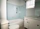 Bathroom with blue tiled walls, a window, and a classic white vanity at 6024 Arlene Way, Bradenton, FL 34207