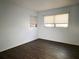 Bedroom features dark wood-look floors and two windows for lots of natural light at 6024 Arlene Way, Bradenton, FL 34207