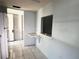 Bright kitchen features white appliances, tiled floors, and pass-through window at 6024 Arlene Way, Bradenton, FL 34207