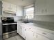 Bright kitchen featuring stainless steel oven and a double sink beneath a window at 6024 Arlene Way, Bradenton, FL 34207