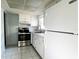Bright kitchen with stainless steel oven, ample white cabinetry, and tiled floor at 6024 Arlene Way, Bradenton, FL 34207