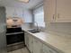 Bright kitchen featuring stainless steel oven and a double sink beneath a window at 6024 Arlene Way, Bradenton, FL 34207
