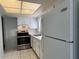 Bright kitchen with stainless steel oven, ample white cabinetry, and tiled floor at 6024 Arlene Way, Bradenton, FL 34207