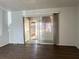 Open living room featuring hard surface flooring and sliding doors to a screened patio at 6024 Arlene Way, Bradenton, FL 34207