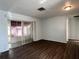 Open living room featuring hard surface flooring and sliding doors to a screened patio at 6024 Arlene Way, Bradenton, FL 34207