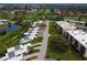 An aerial view showcasing a golf course community with serene ponds and neatly arranged townhomes with easy access to greens at 6116 43Rd W St # 204D, Bradenton, FL 34210