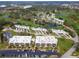 An aerial view displays a beautiful golf community featuring lush green courses, ponds and organized parking at 6116 43Rd W St # 204D, Bradenton, FL 34210