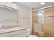 Beautiful bathroom with a granite countertop, modern shower with glass doors and tiled walls at 6116 43Rd W St # 204D, Bradenton, FL 34210