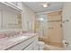 Bathroom featuring a granite vanity and a tiled walk-in shower at 6116 43Rd W St # 204D, Bradenton, FL 34210