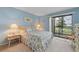 Cozy bedroom features light blue walls, a comfortable queen bed, and sliding glass doors to the balcony at 6116 43Rd W St # 204D, Bradenton, FL 34210