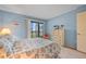 A well-lit bedroom boasts a charming dresser, and a view of the outside from its sliding glass doors at 6116 43Rd W St # 204D, Bradenton, FL 34210
