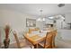 Dining room with a wood table and 6 chairs, view into the kitchen at 6116 43Rd W St # 204D, Bradenton, FL 34210