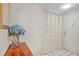 Entryway includes coat closet, and wood-look table with blue flowers at 6116 43Rd W St # 204D, Bradenton, FL 34210