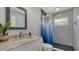 Bathroom features a shower and vanity with a stone countertop and vessel sink at 619 Buttonwood Dr, Longboat Key, FL 34228