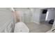 Elegant bathroom with a freestanding tub, glass block shower, plank accent wall and tiled flooring at 619 Buttonwood Dr, Longboat Key, FL 34228