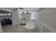 Elegant bathroom featuring a freestanding tub, plank accent wall and dual sink vanity near the bedroom at 619 Buttonwood Dr, Longboat Key, FL 34228