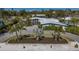 Stunning single-story home with lush landscaping, circular driveway, and modern architectural design at 619 Buttonwood Dr, Longboat Key, FL 34228