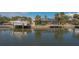 Waterfront exterior view of a screened-in pool at 619 Buttonwood Dr, Longboat Key, FL 34228