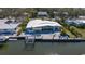 Waterfront home with boat dock, pergola, and modern patio furniture with a canal view at 619 Buttonwood Dr, Longboat Key, FL 34228