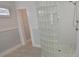 Shower with glass block and stone flooring along with plank accent wall and window at 619 Buttonwood Dr, Longboat Key, FL 34228