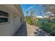 Paver side yard with decorative landscaping and white exterior of single story home at 619 Buttonwood Dr, Longboat Key, FL 34228