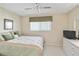 Bright bedroom with neutral walls and carpet features a window bringing in natural light at 649 S Tamiami Trl # 210, Venice, FL 34285