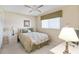 This bedroom features a ceiling fan and a window allowing natural light and refreshing the space at 649 S Tamiami Trl # 210, Venice, FL 34285