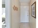 Beige tiled entryway with a coat rack and door with gold hardware at 649 S Tamiami Trl # 210, Venice, FL 34285