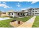 Inviting condo exterior featuring well-maintained landscaping and a charming covered porch at 649 S Tamiami Trl # 210, Venice, FL 34285