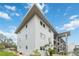 Exterior of building showing the roof, staircases, several windows, and tropical landscaping at 649 S Tamiami Trl # 210, Venice, FL 34285