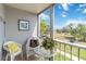 Screened lanai offering views of the green landscape and bright sky at 649 S Tamiami Trl # 210, Venice, FL 34285